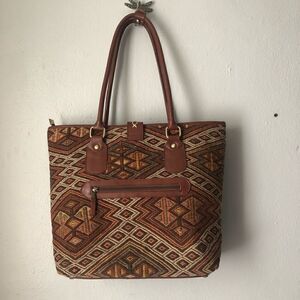 The Loom Alaska woven carpet bag with leather trim in natural colors